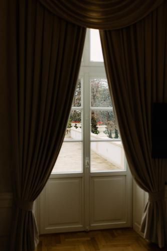 a large window with curtains in a room at GOYA Vitality Hotel in Voderady