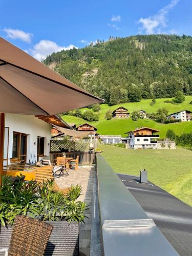 a house with a patio with a view of a mountain at Restaurant Appartements Almdiele in Hart im Zillertal