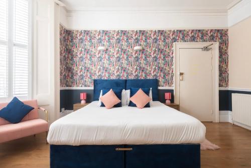 a bedroom with a large bed with a blue headboard at INNit Blue Sky in Brighton & Hove