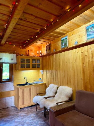 a kitchen with a sink and a bench in a room at Domek pod Modrzewiem in Nowy Targ