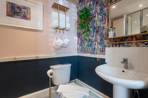 a bathroom with a toilet and a sink at INNit Blue Sky in Brighton & Hove