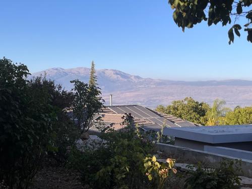 a row of solar panels on top of a roof at שלווה בהר in Malkiyya