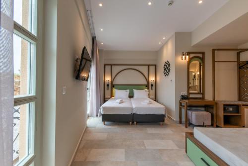 a bedroom with a bed and a large window at El Greco Hotel in Chania Town
