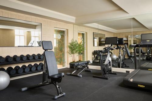 a gym with several treadmills and exercise machines at Milestone Hotel Kensington in London
