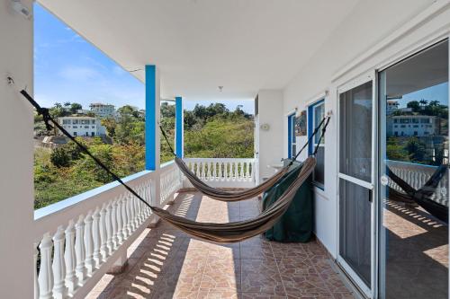 a hammock on the balcony of a house at Vista del Mar terrace with pool table and views in Rincon