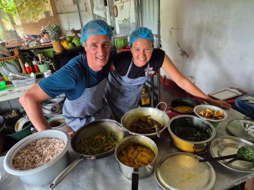 two women standing in a kitchen preparing food at Ella Nature Life Guest & Restaurant -Free Pickup from Ella in Ella