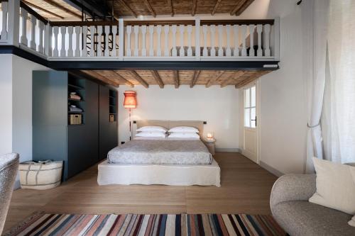 a bedroom with a bed and a loft at Boutique Guesthouse GIUS La Damaglück in Marciaga