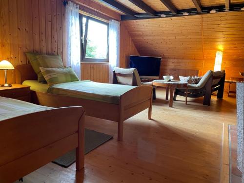 a room with two beds and a couch and a tv at Bunnyhill in Elchingen