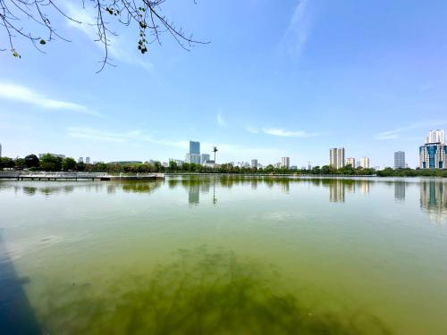a large body of water with a city in the background at Delux Stu Apt In Vinhomes, Close to JW Marriott, Keangnam and My Dinh in Hanoi