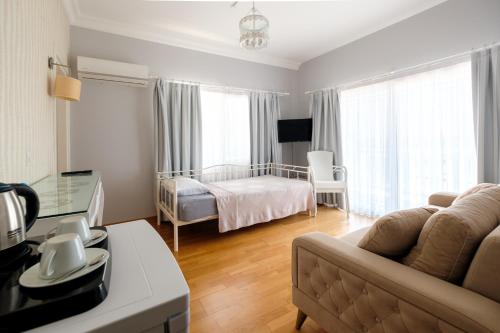 a living room with a couch and a bed at Miray Guest House Boutique Hotel in Iskele