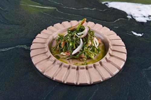 a paper plate of food on a table at RUKA Hotel in Narlıdere