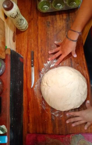 a person is making a dough on a cutting board at Curiango Bird Camp in Puerto Iguazú