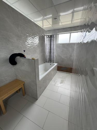a white bathroom with a tub and a window at Байлово SPA 