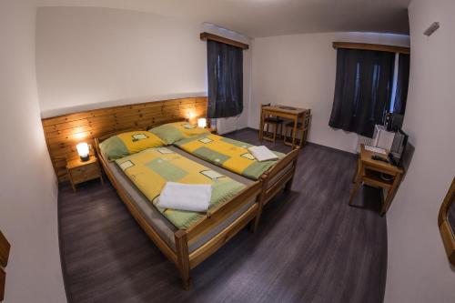 a bedroom with a large bed in a room at Horské Apartmány Smrčina in Janske Lazne