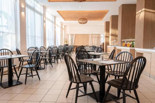 a row of tables and chairs in a restaurant at Smy Kos Beach & Splash in Mastichari