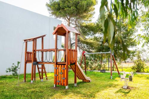 a playground with a slide and a swing at Smy Kos Beach & Splash in Mastichari