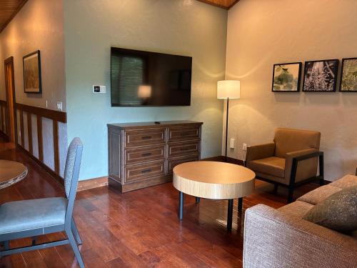 a living room with a couch and a table and a tv at Stonewater Cove in Shell Knob