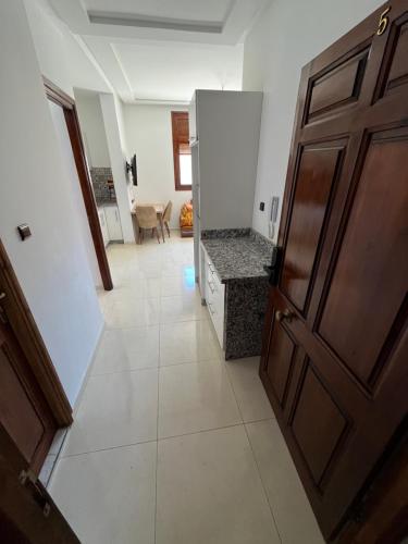 a hallway with a wooden door and a room at La Casa Luminosa 5 in Larache