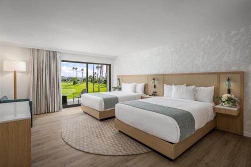 a hotel room with two beds and a balcony at Guesthouse, Hotel at La Valle in Rancho Santa Fe