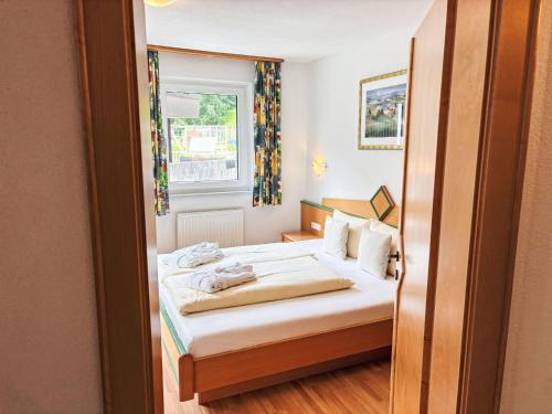 a small room with a bed with a window at Apartment Apart Edi by Interhome in Kappl