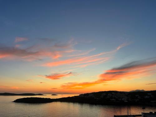 a sunset over a body of water with the sky at Theros (Θέρως) in Batsi