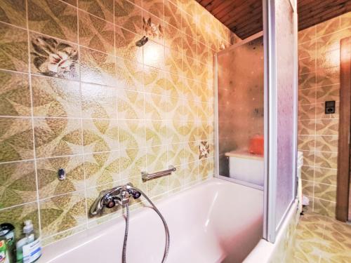 a bathroom with a bath tub with a shower at Apartment Angelika by Interhome in Brixlegg
