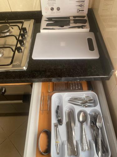 a drawer filled with utensils in a kitchen at Apartamento T2 em Palmarejo in Prainha