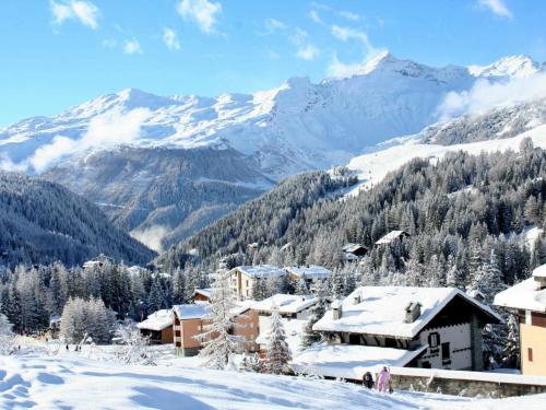 a ski resort in the snow with mountains in the background at Apartment Pino Bianco by Interhome in Madesimo