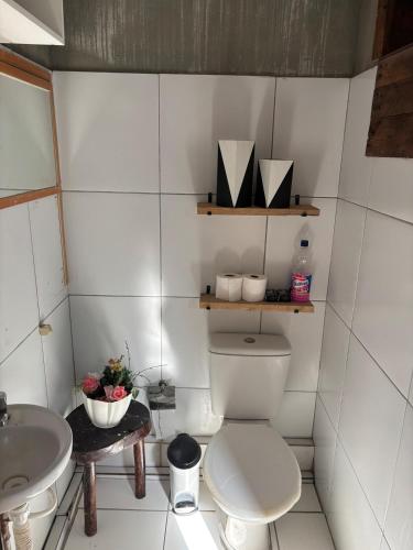 a bathroom with a toilet and a sink at Dunamis in São Gonçalo do Amarante