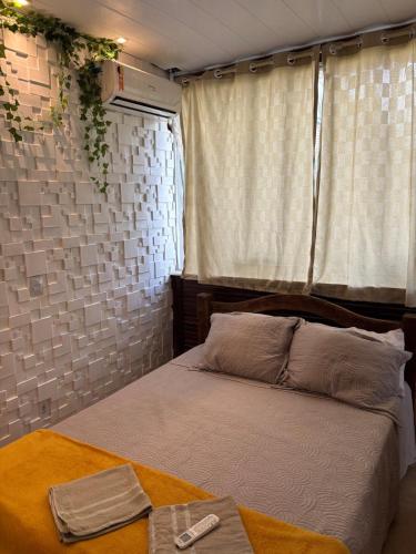 a bedroom with a bed and a window at Dunamis in São Gonçalo do Amarante