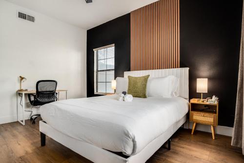 a bedroom with a large white bed and a desk at Boulevard Stays Quiet Modern 2BR Pickleball Pool Parking Gym 05 in Chandler