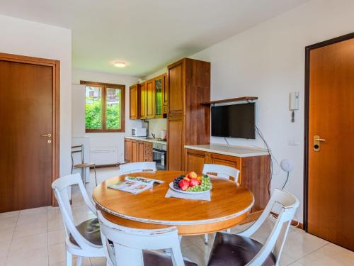 a kitchen with a table with a bowl of fruit on it at Apartment Borgo Castello-5 by Interhome in Argegno