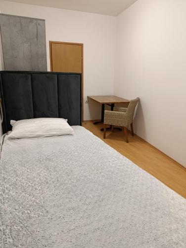 a bedroom with a large bed and a table at Međimurski San in Lopatinec