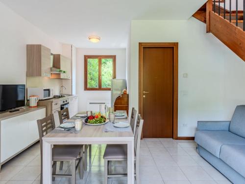a kitchen and living room with a table and chairs at Apartment Borgo Castello-3 by Interhome in Argegno