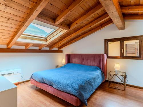 a bedroom with a bed and a wooden ceiling at Apartment Borgo Castello-3 by Interhome in Argegno