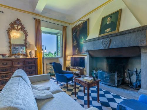 a living room with a couch and a fireplace at Holiday Home Villa Mandri by Interhome in Castelfranco Piandisco