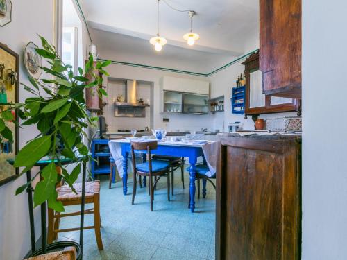 a kitchen with a blue table and some chairs at Holiday Home Villa Mandri by Interhome in Castelfranco Piandisco