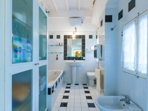a bathroom with a tub toilet and a sink at Holiday Home Villa Mandri by Interhome in Castelfranco Piandisco