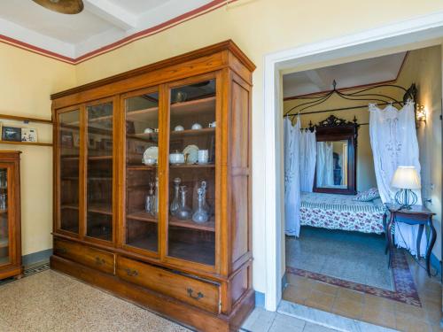 a large wooden cabinet in a room with a bed at Holiday Home Villa Mandri by Interhome in Castelfranco Piandisco