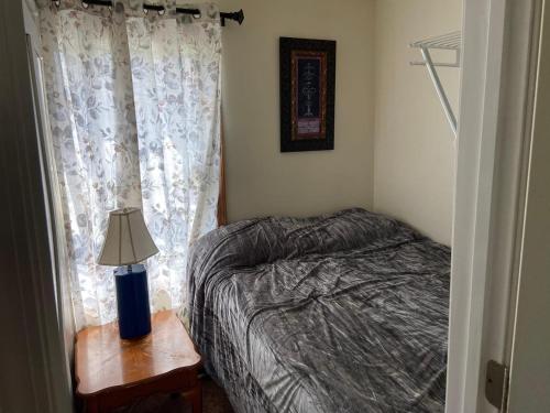 a bedroom with a bed and a lamp on a table at Large Country Home in Bloomington