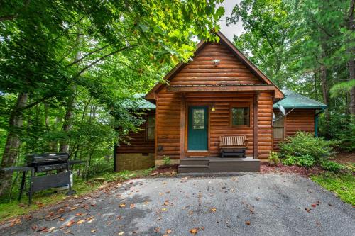 a log cabin with a bench in front of it at Hills Hideaway in Sevierville