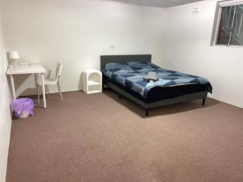 a bedroom with a bed with a teddy bear on it at Ground Level Apartment with Pool in Sydney