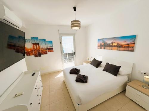 En eller flere senge i et værelse på Villa New York