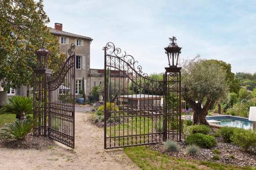 a pair of gates in front of a house at Villa Po'Strophe - Bâtiment classé avec piscine in Clisson