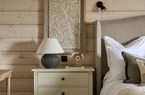 a bedroom with a bed with a lamp on a night stand at Stretton Hills Peaks - The Georgian House in Ludlow