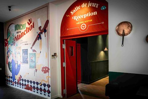 a hallway with a red door and a wall with a sign at B&B HOME Brides-les-Bains Les 3 Vallées in Brides-les-Bains