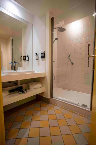 a bathroom with a shower and a sink and a tub at B&B HOME Brides-les-Bains Les 3 Vallées in Brides-les-Bains