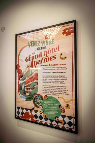 a framed movie poster on a wall at B&B HOME Brides-les-Bains Les 3 Vallées in Brides-les-Bains