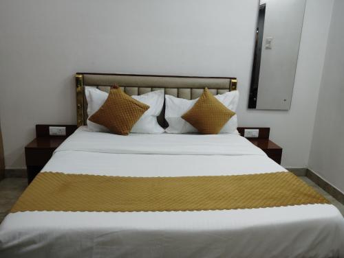 a bedroom with a large bed with white sheets and pillows at Hotel Quality Stay in Hyderabad