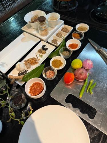 a table with many different food items on it at Pekoetrails Hantana Homestay in Kandy